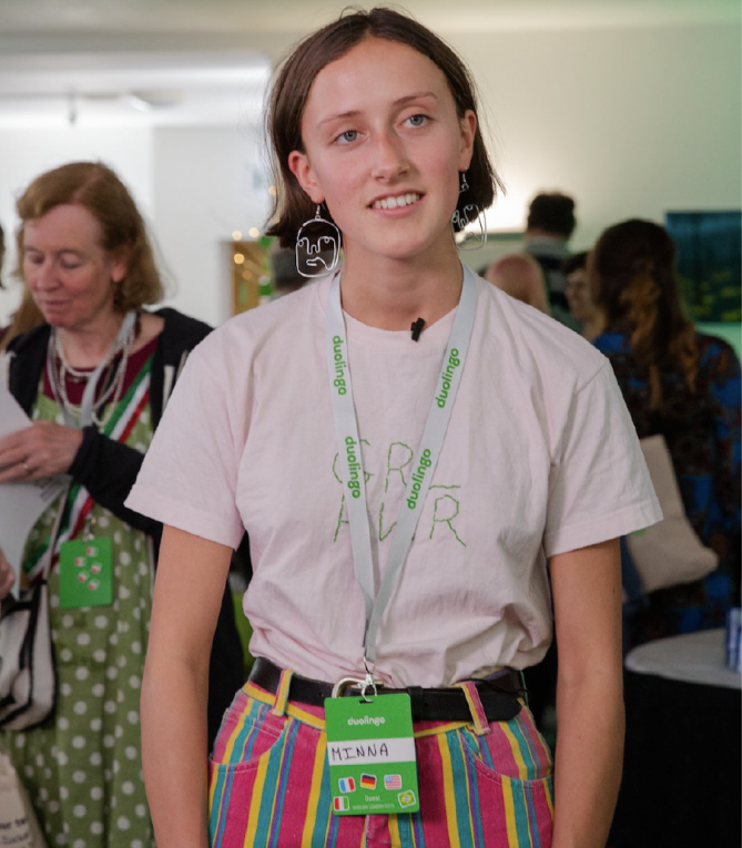 Attendee wearing a GRL PWR shirt and Duolingo badge