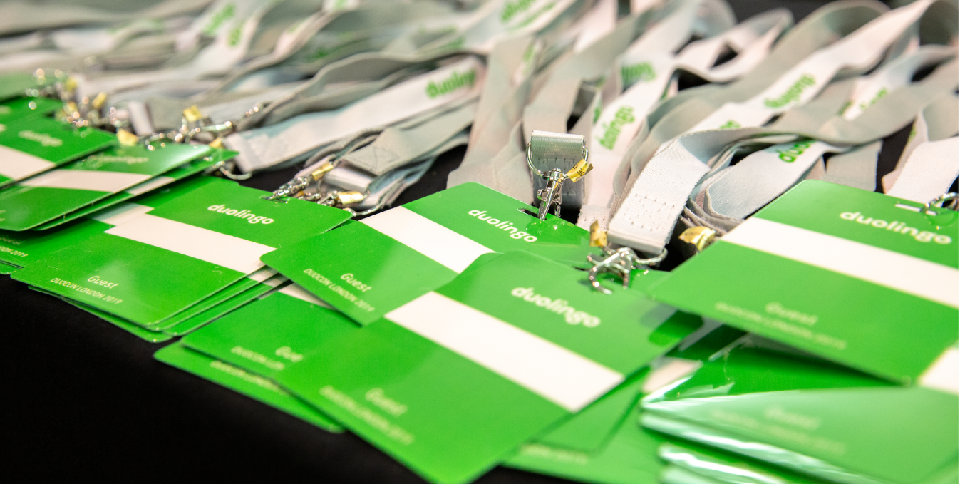 Blank green Duolingo badges on lanyards