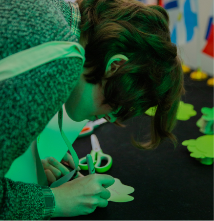 Attendee writing on a Duo-shaped leaf