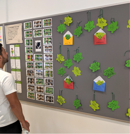 Staff member looking at the feedback wall back at HQ